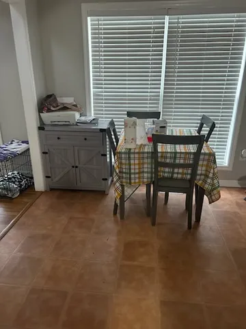 a view of a room that has a window and a chair