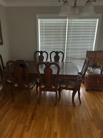 a view of a workspace with furniture and wooden floor