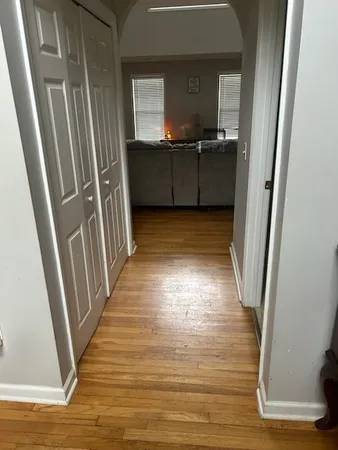 a view of hallway with wooden floor