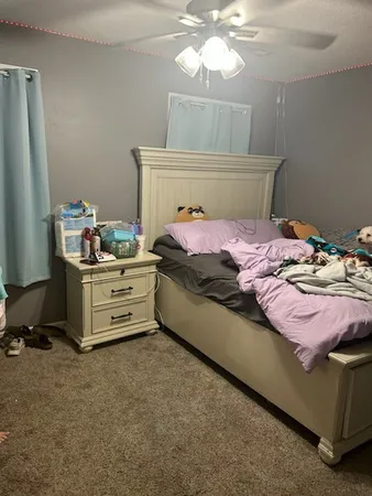 a bedroom with a bed and a chandelier