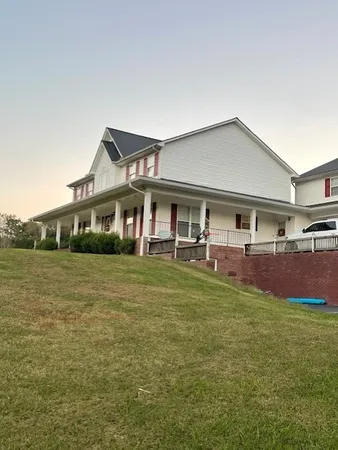 a front view of a house with a yard table and chairs