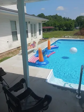 a view of swimming pool with outdoor seating and yard