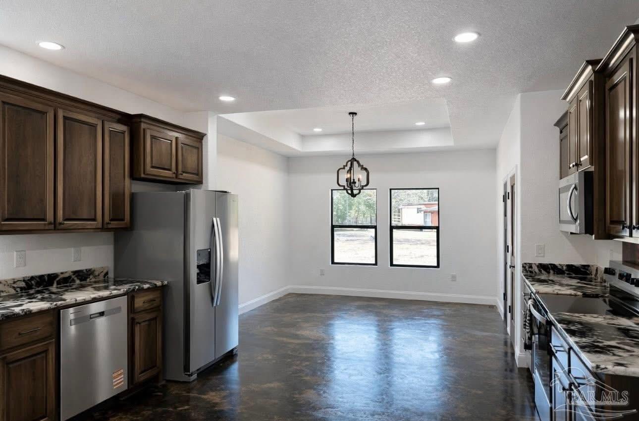 4835 Green Rowell Road Jay, FL 32565 - Photo 7 of 20 a kitchen with stainless steel appliances granite countertop a stove refrigerator sink and microwave