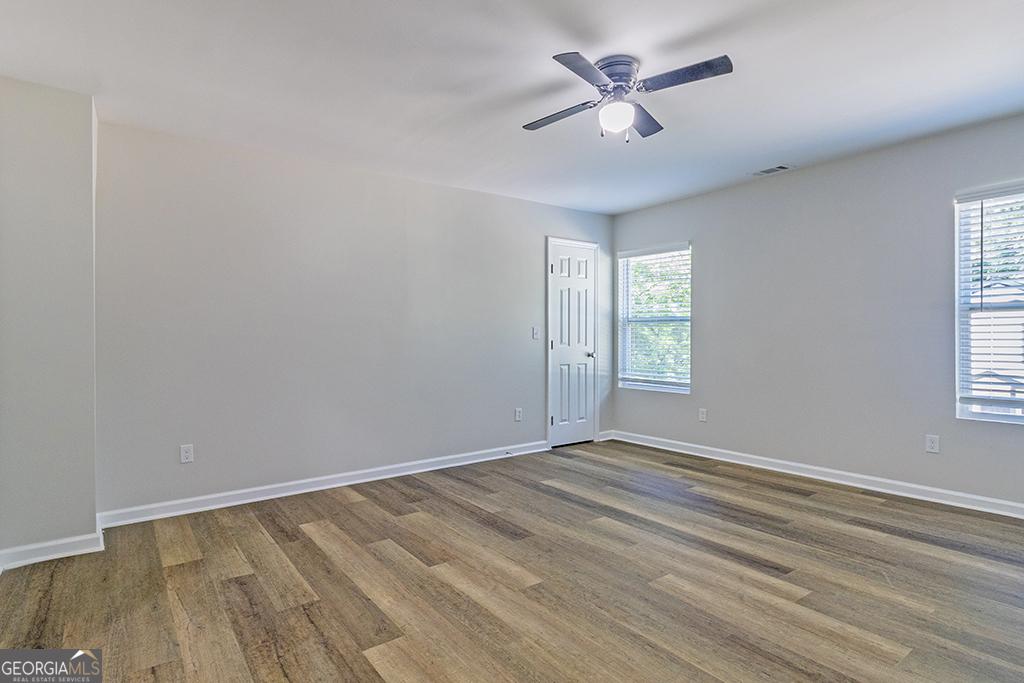 789 Main Street Macon, GA 31217 - Photo 14 of 19 wooden floor in an empty room with a window