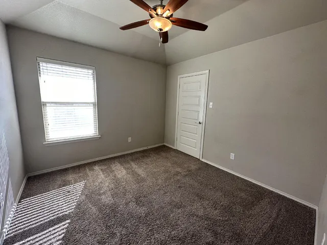a view of a livingroom with a ceiling fan and window