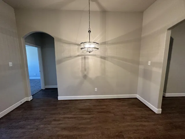 an empty room with wooden floor and door