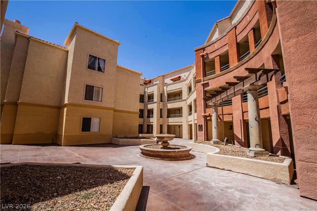 230 East Flamingo Road, Unit 122 Las Vegas, NV 89169 - Photo 2 of 7 A tranquil fountain anchors this inviting courtyard within a multi-story residential complex.
