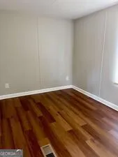 a view of a room with wooden floor