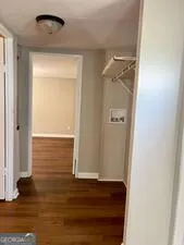 an empty room with wooden floor and closet