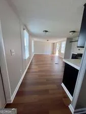 a view of an empty room and wooden floor in a room