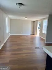 a view of room with window and wooden floor