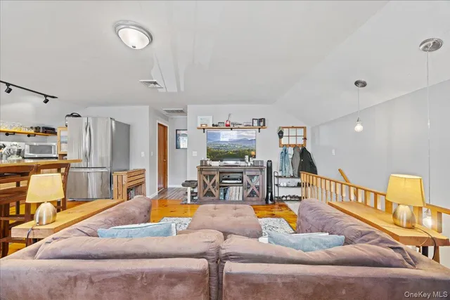 a kitchen with stainless steel appliances granite countertop a table chairs sink and cabinets