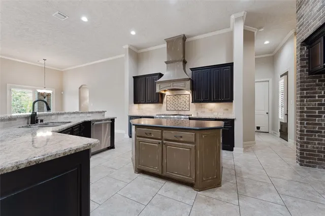 a kitchen with a sink counter top space appliances and cabinets