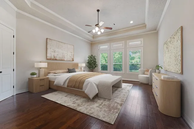 a spacious bedroom with a large bed and a chandelier