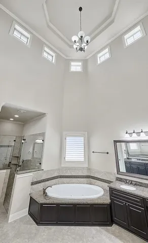a spacious bathroom with a tub double sink and shower
