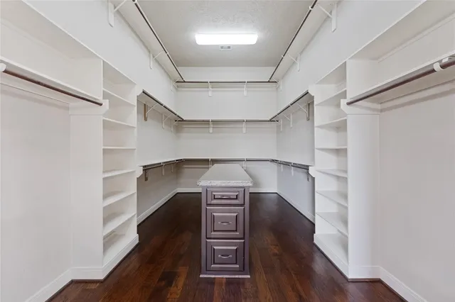 a view of hallway with stairs and wooden floor