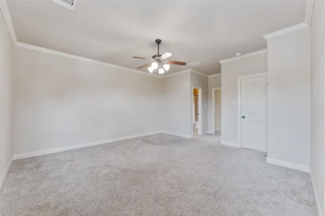 a view of an empty room with a ceiling fan