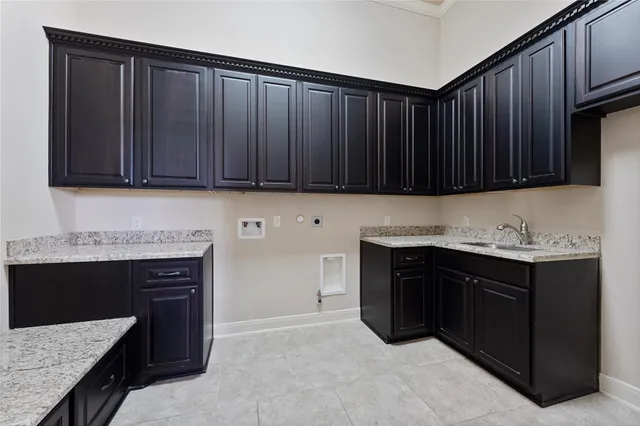 a kitchen with granite countertop wooden cabinets and a stove top oven