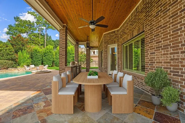 a view of a patio with couches table and chairs and potted plants