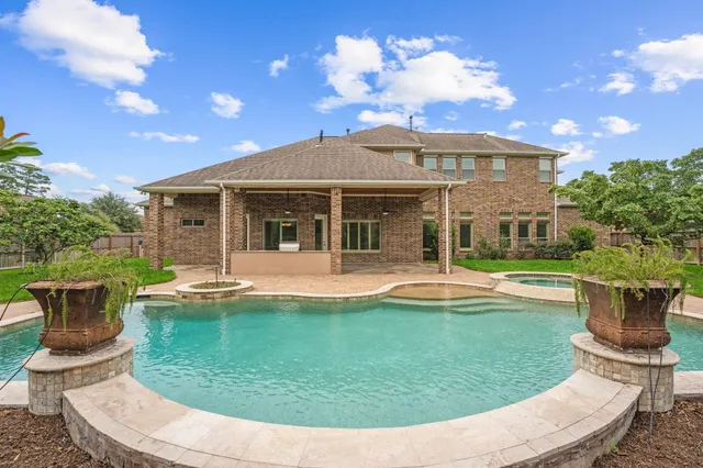 a view of a house with sitting area and garden
