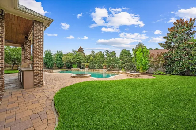 a view of a swimming pool with an outdoor seating and a yard