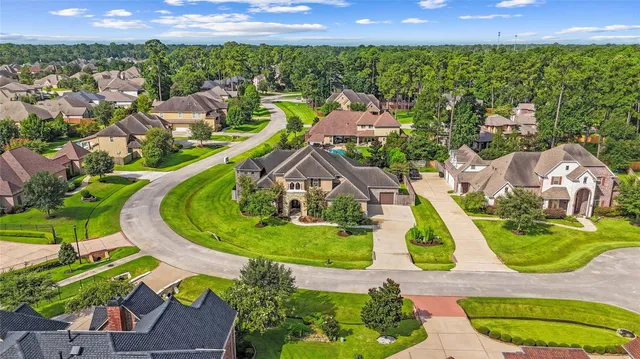 an aerial view of a house with outdoor space pool patio and lake view