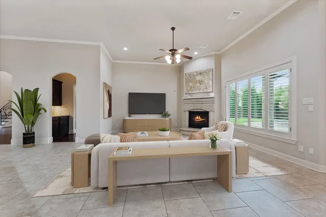 a living room with furniture a fireplace and a flat screen tv