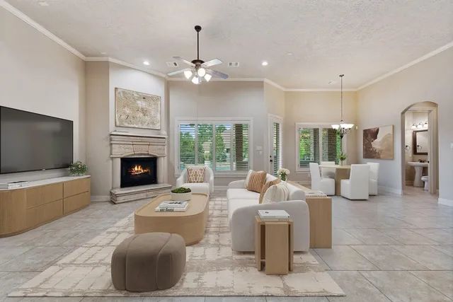 a living room with furniture a flat screen tv and a fireplace