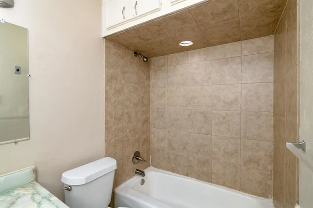 a bathroom with a shower and a toilet