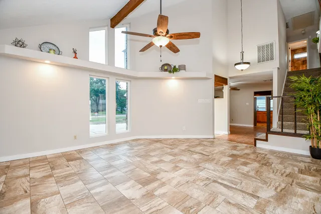 a bedroom with a large bed and a large window