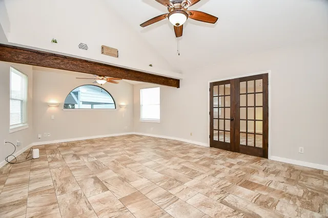 a spacious bathroom with a granite countertop sink a mirror and shower