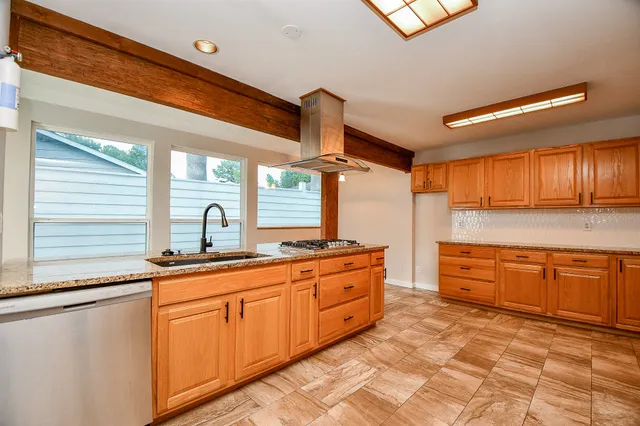 a view of a hallway with dining area and chandelier