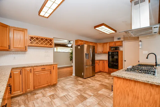 a view of workspace with furniture window and a ceiling fan