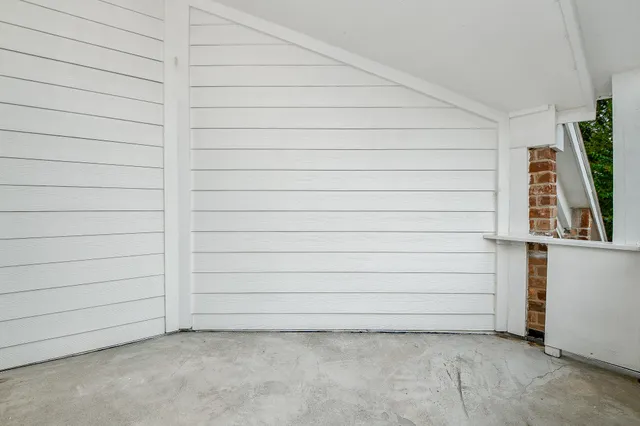 an empty room with ceiling fan and window