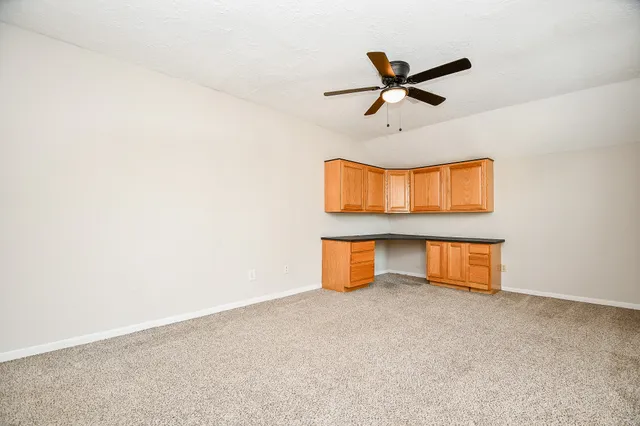 a bathroom with a granite countertop bathtub sink vanity mirror and toilet