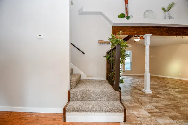 a view of a livingroom with a ceiling fan and window