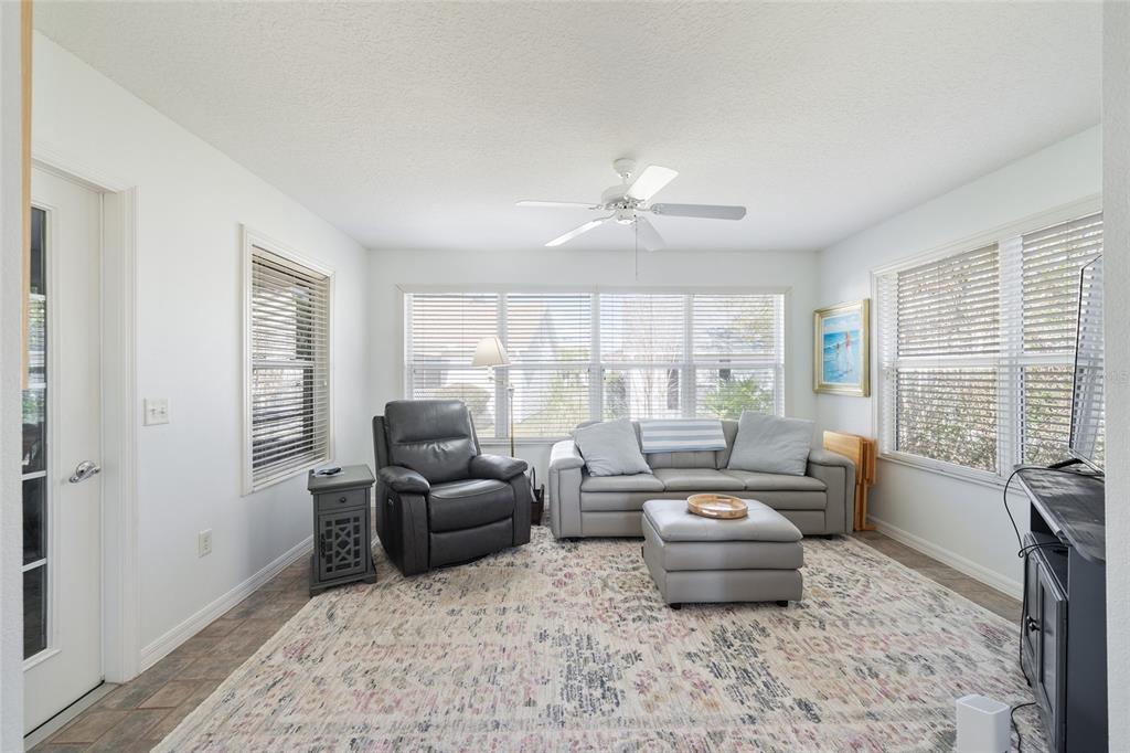 3073 Riverdale Road The Villages, FL 32162 - Photo 13 of 38 a living room with furniture and a large window