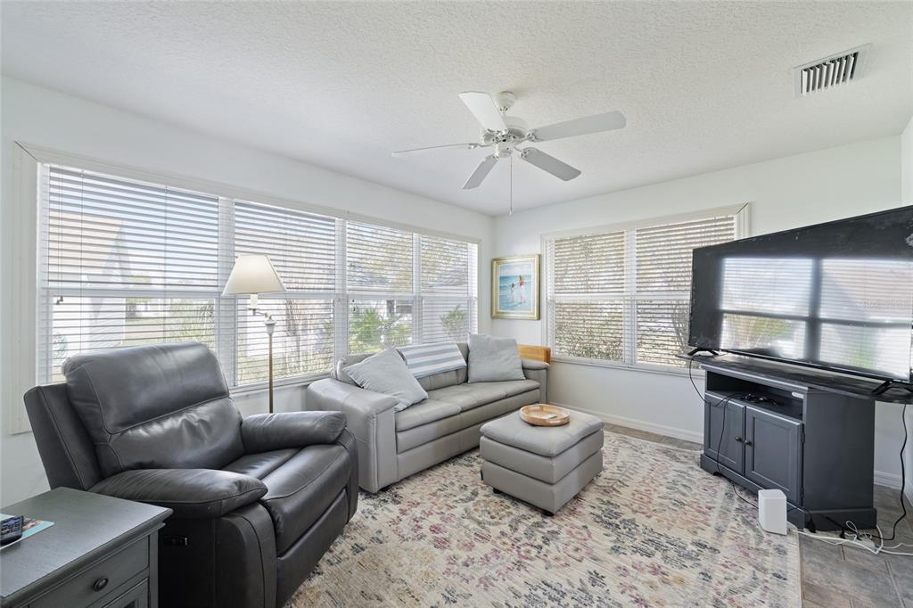 3073 Riverdale Road The Villages, FL 32162 - Photo 14 of 38 a living room with furniture and a large window