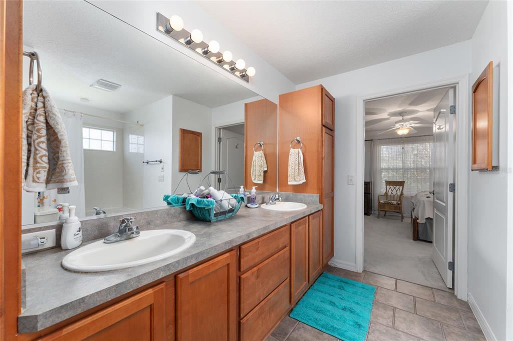 3073 Riverdale Road The Villages, FL 32162 - Photo 22 of 38 a bathroom with a sink double vanity granite and a mirror