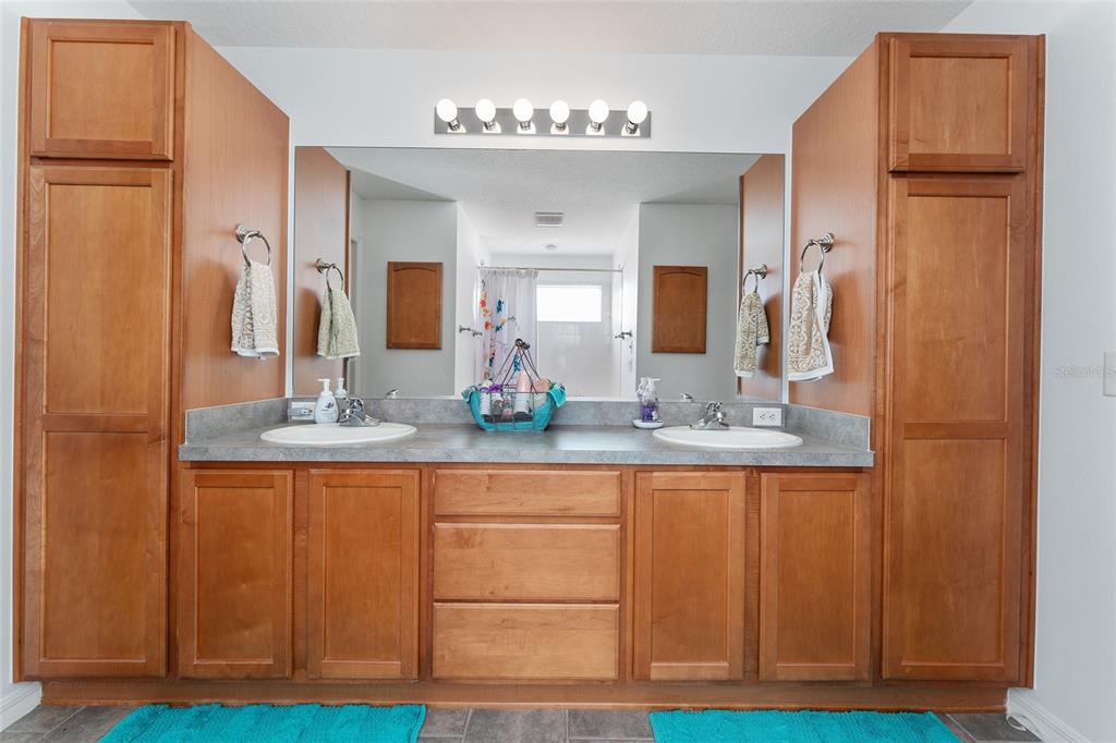 3073 Riverdale Road The Villages, FL 32162 - Photo 23 of 38 a bathroom with a granite countertop sink and a mirror