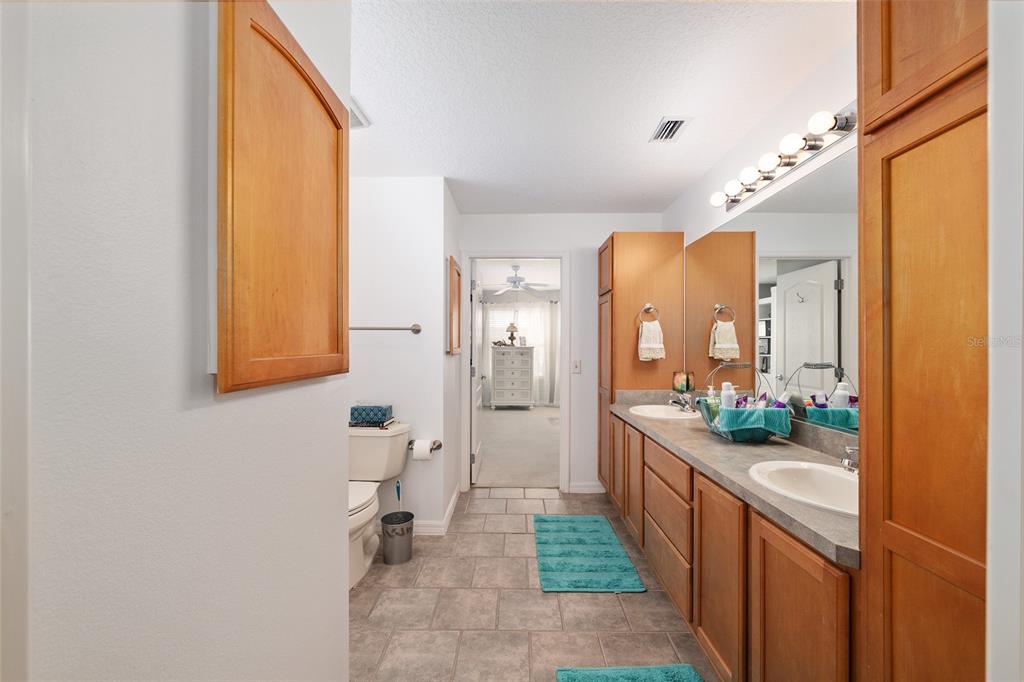 3073 Riverdale Road The Villages, FL 32162 - Photo 27 of 38 a bathroom with a sink a mirror and a shower