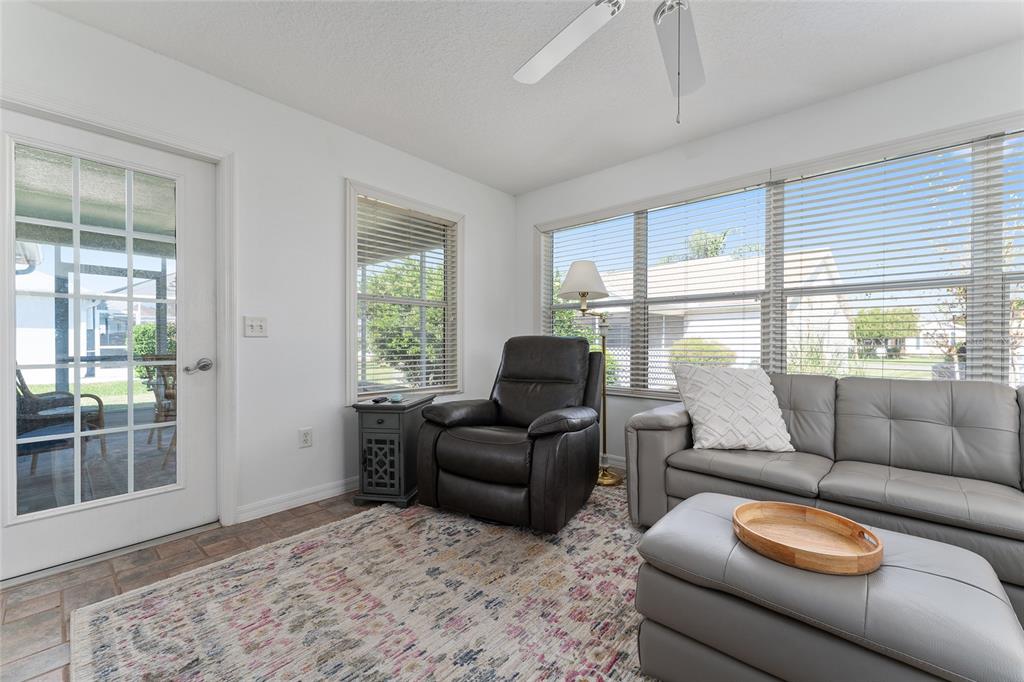 3073 Riverdale Road The Villages, FL 32162 - Photo 29 of 38 a living room with furniture and a large window