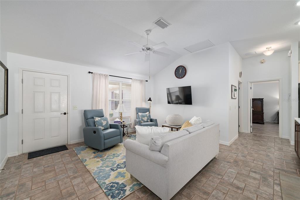 3073 Riverdale Road The Villages, FL 32162 - Photo 7 of 38 a living room with furniture and a flat screen tv