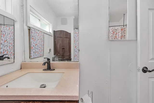 a view of a house with a yard and pathway