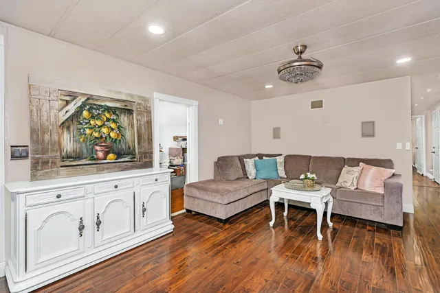 a living room with furniture and wooden floor