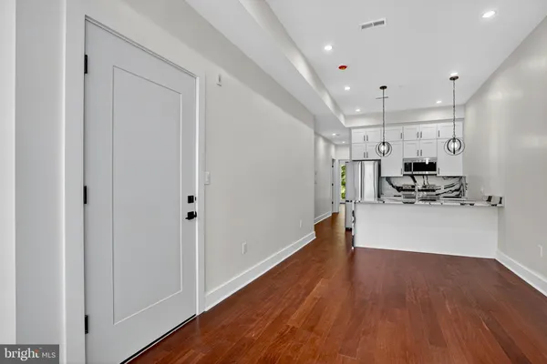 a kitchen with stainless steel appliances a refrigerator a sink dishwasher a stove and a microwave