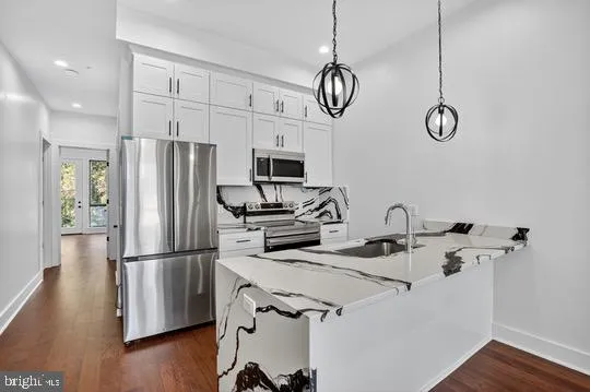 a kitchen with a refrigerator and a sink
