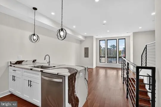 a kitchen with a sink appliances and cabinets