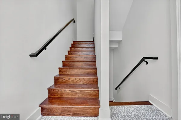 a view of kitchen with stainless steel appliances refrigerator stove microwave and cabinets