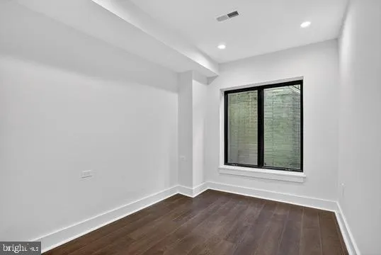 a view of a bathroom with a sink mirror and window